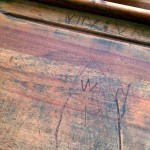 names carved into antique wooden school desk