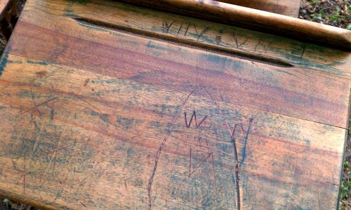 names carved into antique wooden school desk