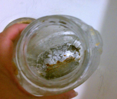 stuff in bottom of old glass bottle jar