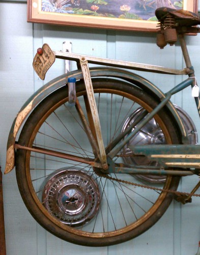 hubcaps behind bike wheel rusty vintage