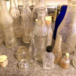 vintage antique glass bottles dug from dirt making spirit bottles