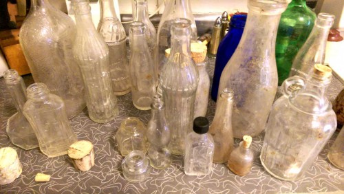 vintage antique glass bottles dug from dirt making spirit bottles