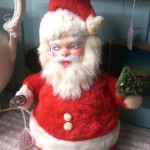 kitschy rubber-faced masked stuffed santa bottle brush tree light