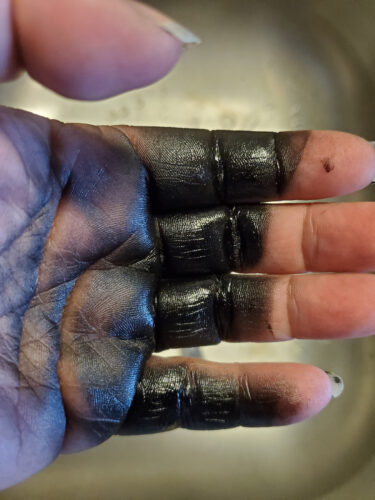 black spray paint on hand